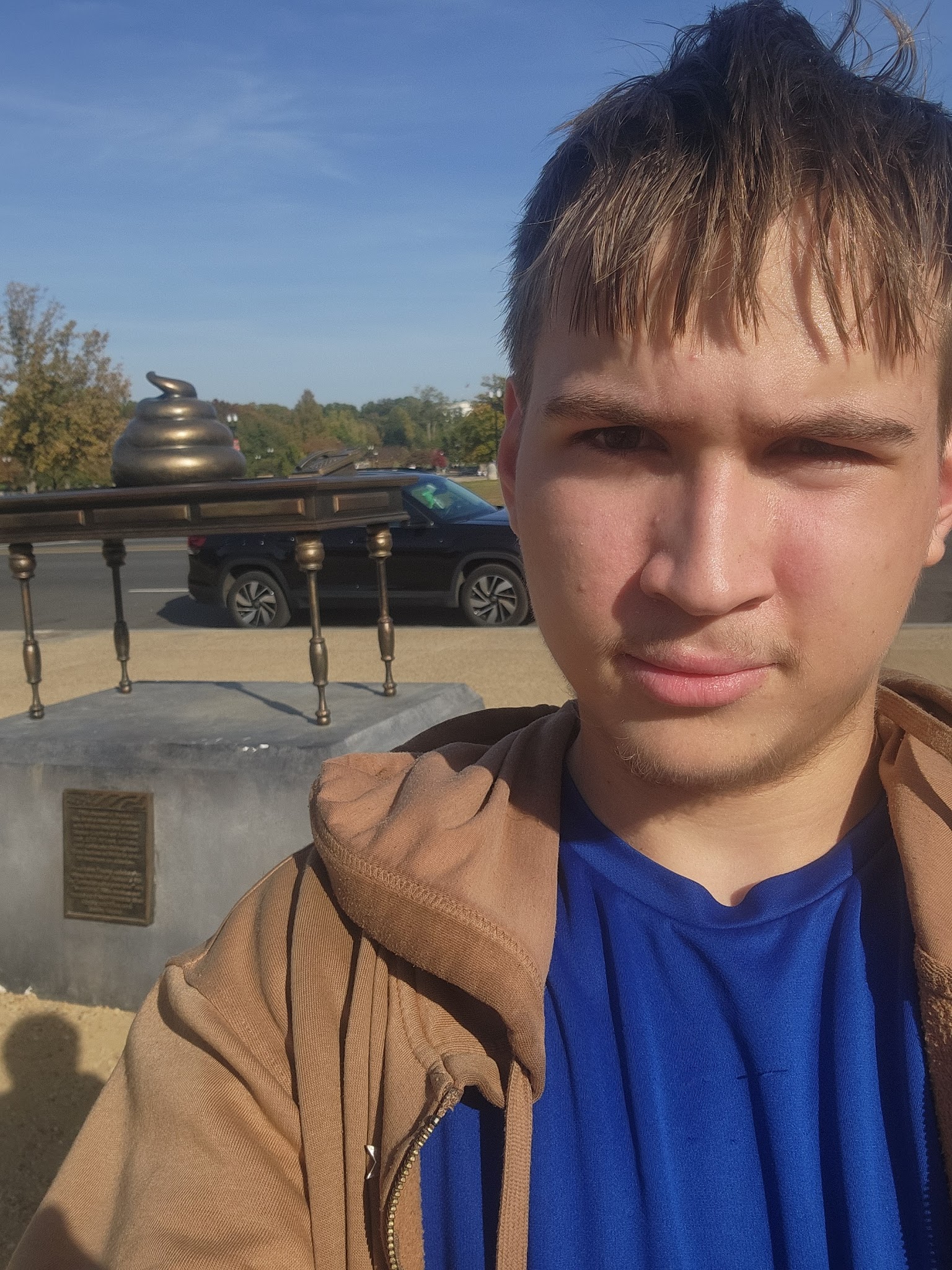 me infront of statue of nancy pelosi's desk with poop on it